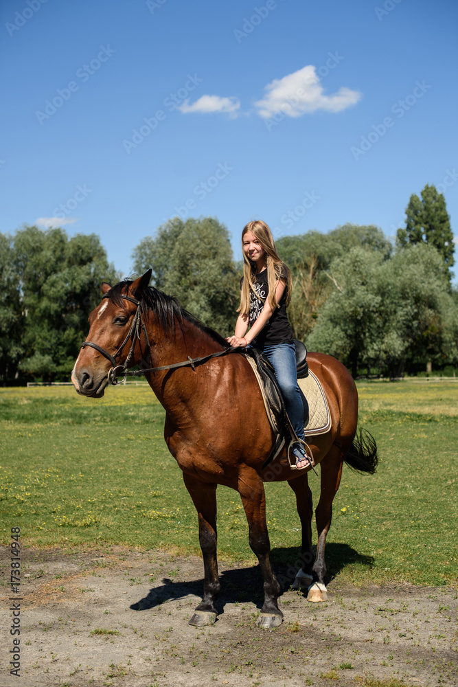 The beautiful girl goes on the horse