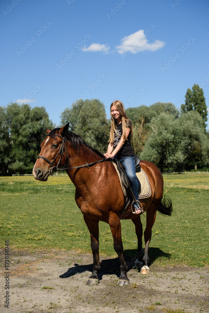 The beautiful girl goes on the horse The beautiful girl goes on the horse