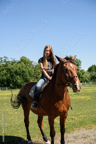 The beautiful girl goes on the horse
