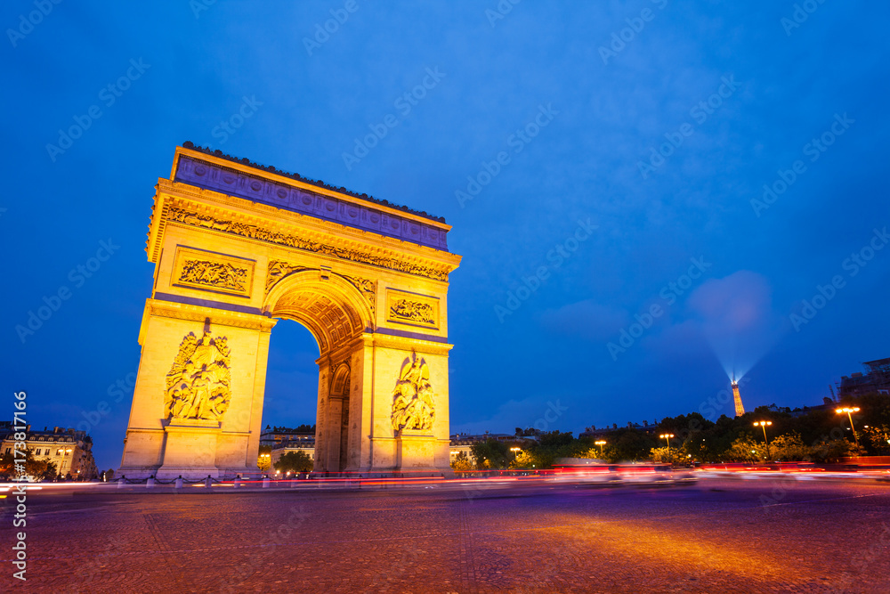 Illuminated Arc de Triomphe at night, Paris