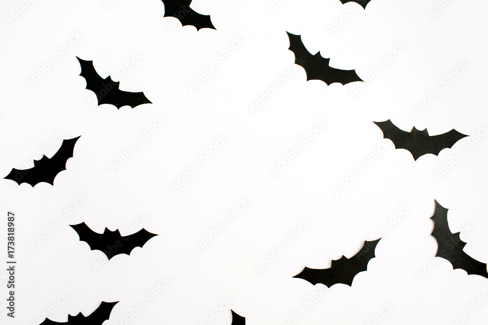 Fototapeta premium Halloween holiday concept. Handmade black paper bats on white background. Flat lay, top view.