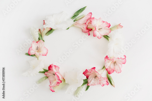 Beautiful pink gladiolus flower frame on white background. Flat lay, top view.