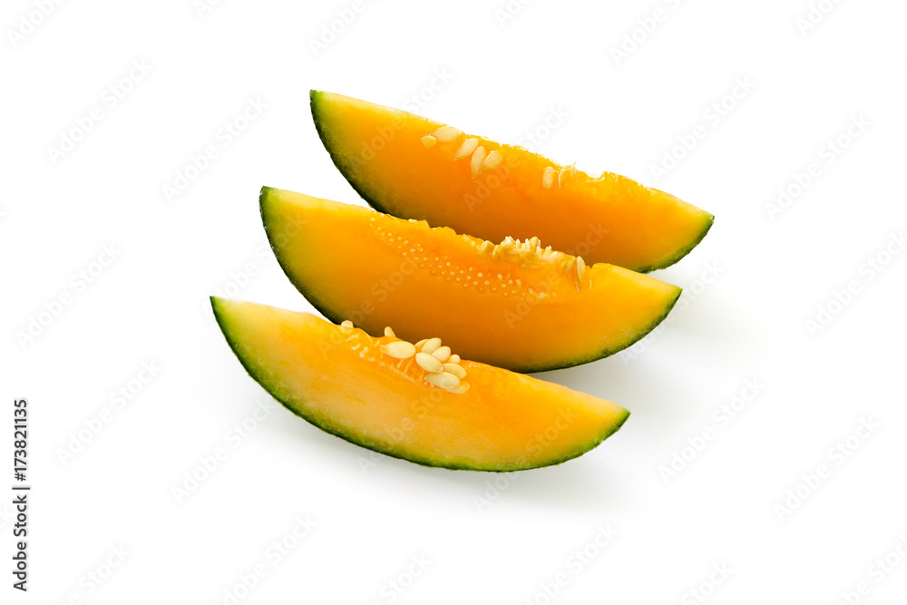 Three cut pieces of ripe yellow melon. With seeds. Isolated on white background Three cut pieces of ripe yellow melon. With seeds. Isolated on white background