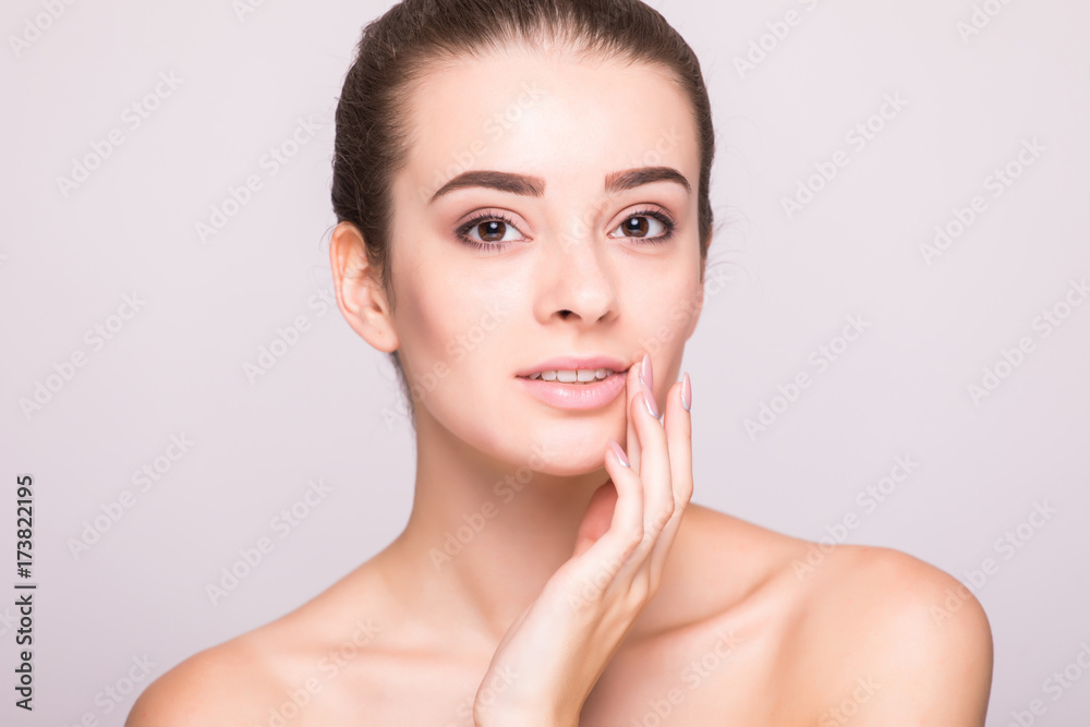 Beauty woman face portrait. Beautiful spa model girl with perfect fresh clean skin. Female looking at camera.