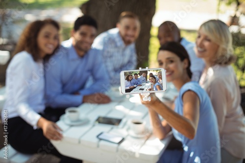 Group of friends taking selfie on mobile phone