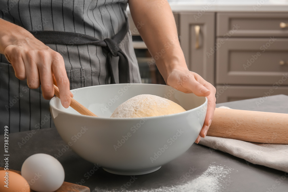 Female chef with dough in bowl on kitchen table Female chef with dough in bowl on kitchen table