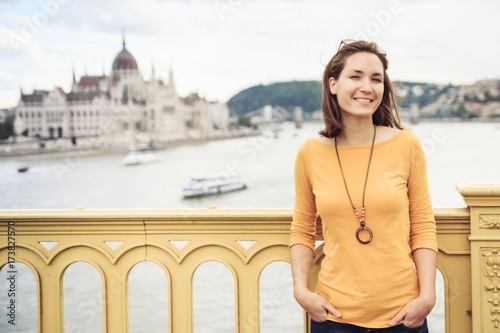 Young happy woman standing on bridge in Budapest, Hungary