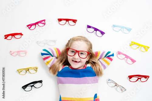 Child at eye sight test. Kid at optitian. Eyewear for kids. photo