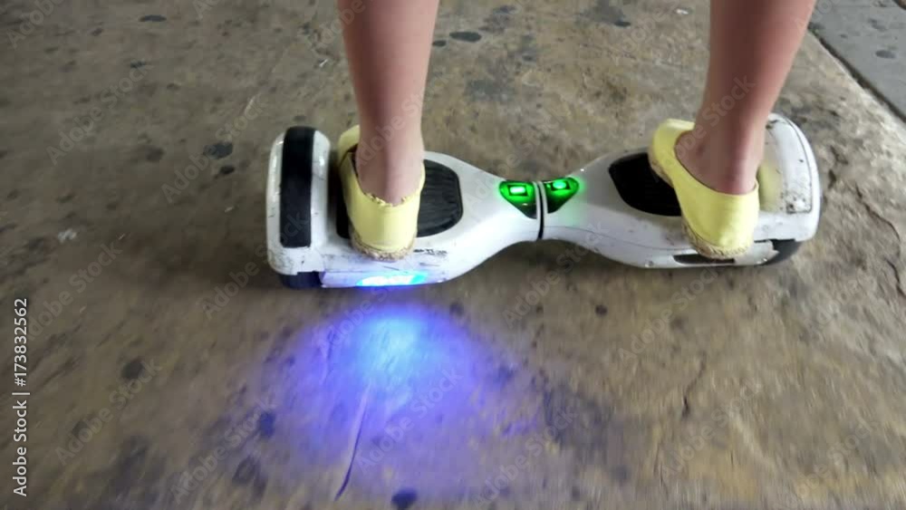 Girl feet on the hover board POV. Mini segway