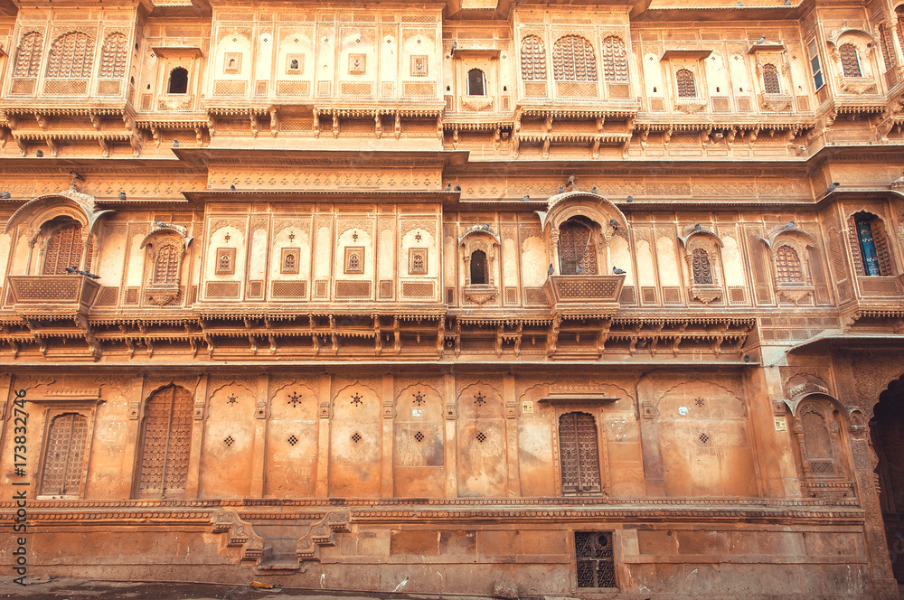 Facade of historical indian house with ancient design of walls and balconies, Rajasthan of India