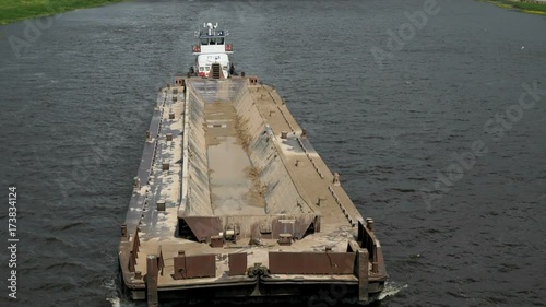 Top view of seascape - empty barge without cargo float along the river in summer sunny day photo