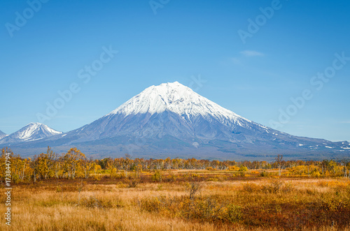 Kamchatka landscape. beautiful autumn view of the active Koryak Volcano and blue sky on clear sunny day.