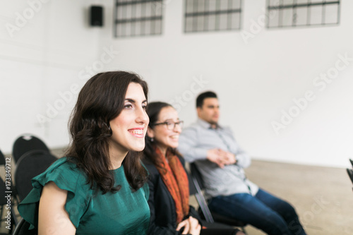 Young woman smiling in an auditorium