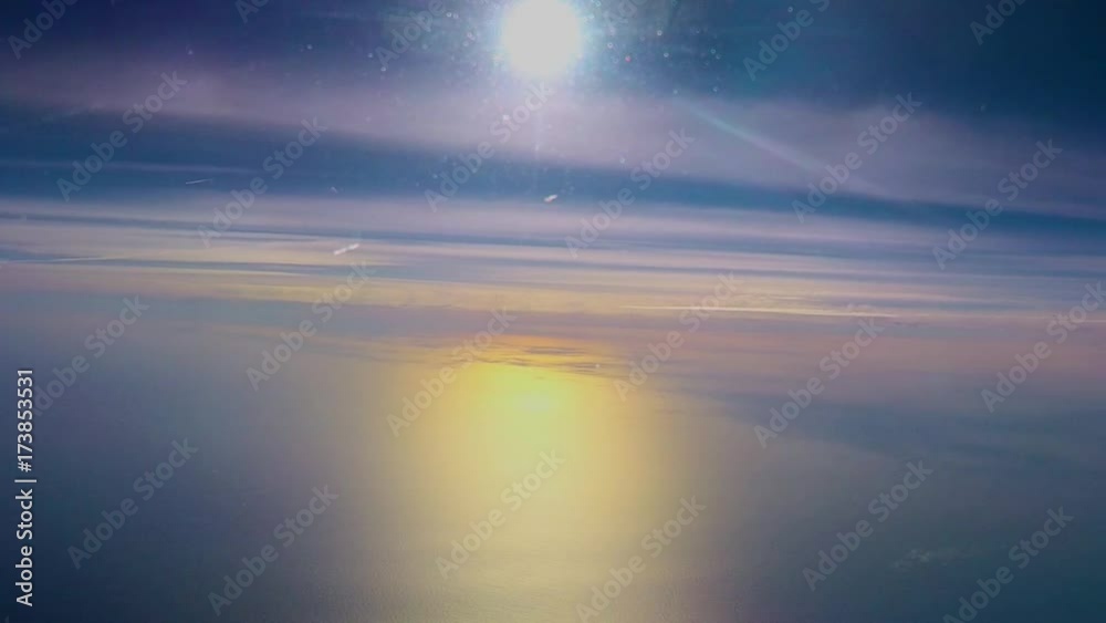 PRECIOUS AIRCRAFT BLUE SKY AND THE REFLECTION OF THE SUN ON THE SEA AND CLOUDS AT SUNSET FROM THE CABIN OF A COMMERCIAL FLIGHT AIRPLANE, SPAIN PRECIOUS AIRCRAFT BLUE SKY AND THE REFLECTION OF THE SUN ON THE SEA AND CLOUDS AT SUNSET FROM THE CABIN OF A COMMERCIAL FLIGHT AIRPLANE, SPAIN