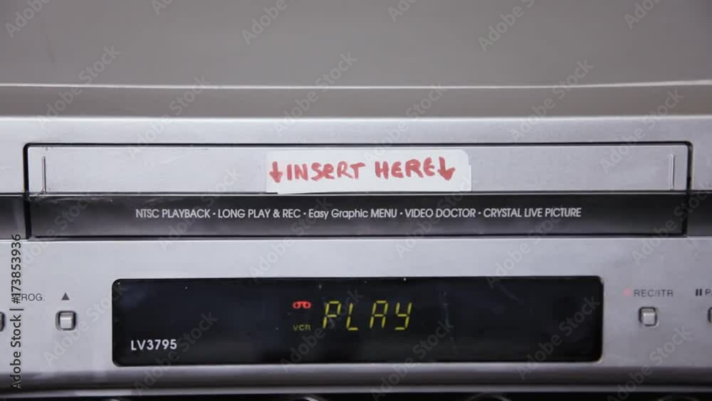 Inserting and removing a VHS tape from a VCR. The title says Our honeymoon.
