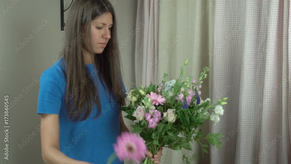 Attractive thirty-year-old woman florist makes a bouquet in a flower shop 4k. Attractive thirty-year-old woman florist makes a bouquet in a flower shop 4k.