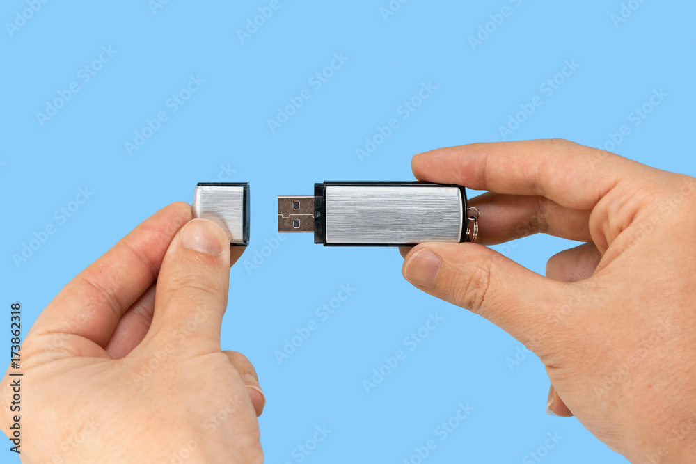 Metal memory stick on hand with blue background Metal memory stick on hand with blue background