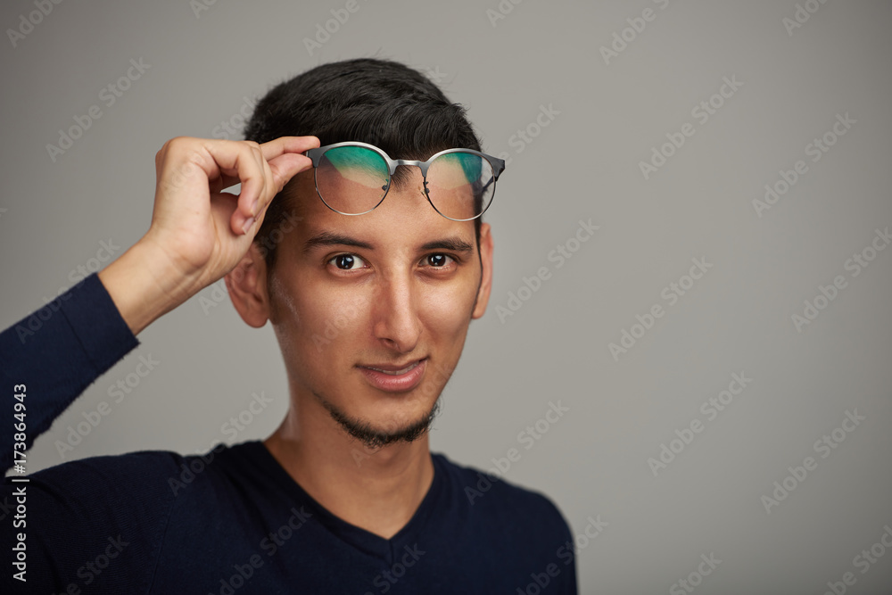 Obraz premium Young man with glasses on forehead