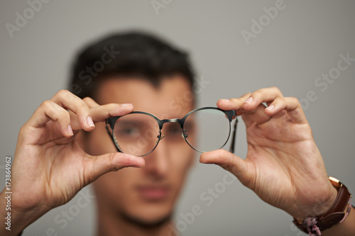 Glasses on man hands