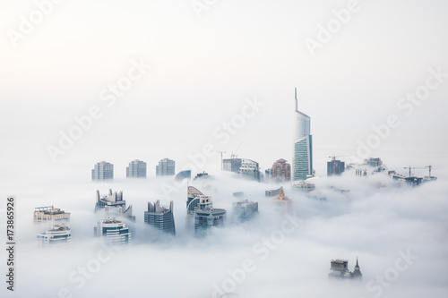 Canvas Print World's tallest skyscrapers surrounded by dense fog on a winter morning