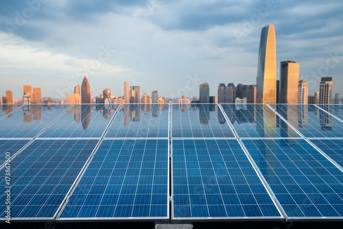 solar energy panel with city twilight photo