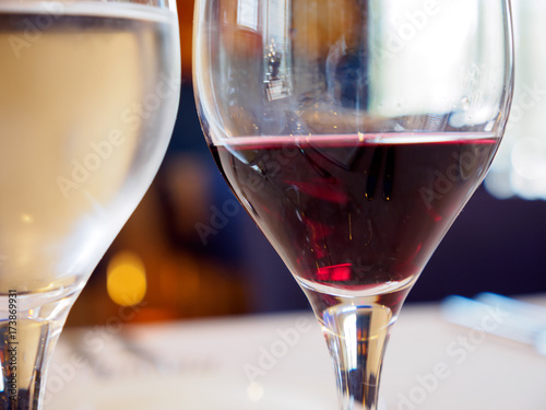 Close-up macro detail of a glass of red and white wine at a gourmet restaurant. Valencia, Spain. Food and drinks concept.