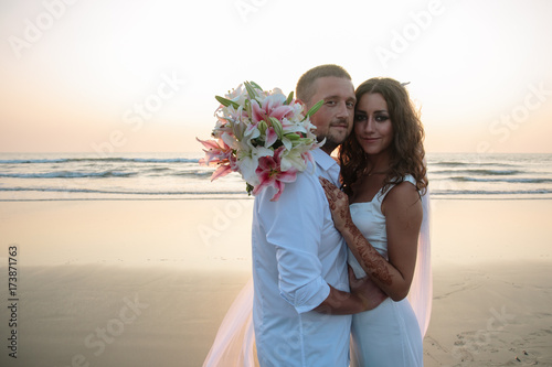 Lovers were married in India. Walk on the beach
