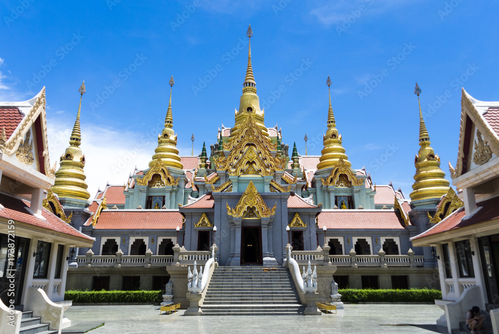 Fototapeta premium temple withe golden pagoda and blue sky, build on mountains.