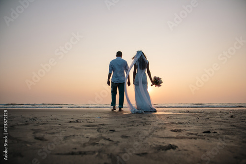 Lovers were married in India. Walk on the beach photo