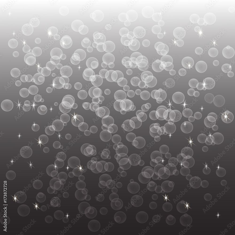 Soap bubbles and lights on a gray gradient background. Beautiful abstract background.