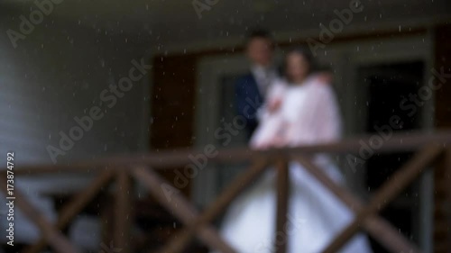 Wallpaper Mural The bride and the groom standing on the porch of the house, when it's snowing with rain Torontodigital.ca