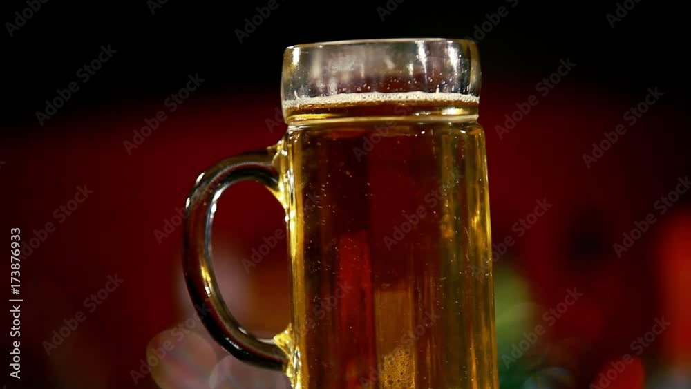 A glass of beer is on the bar.