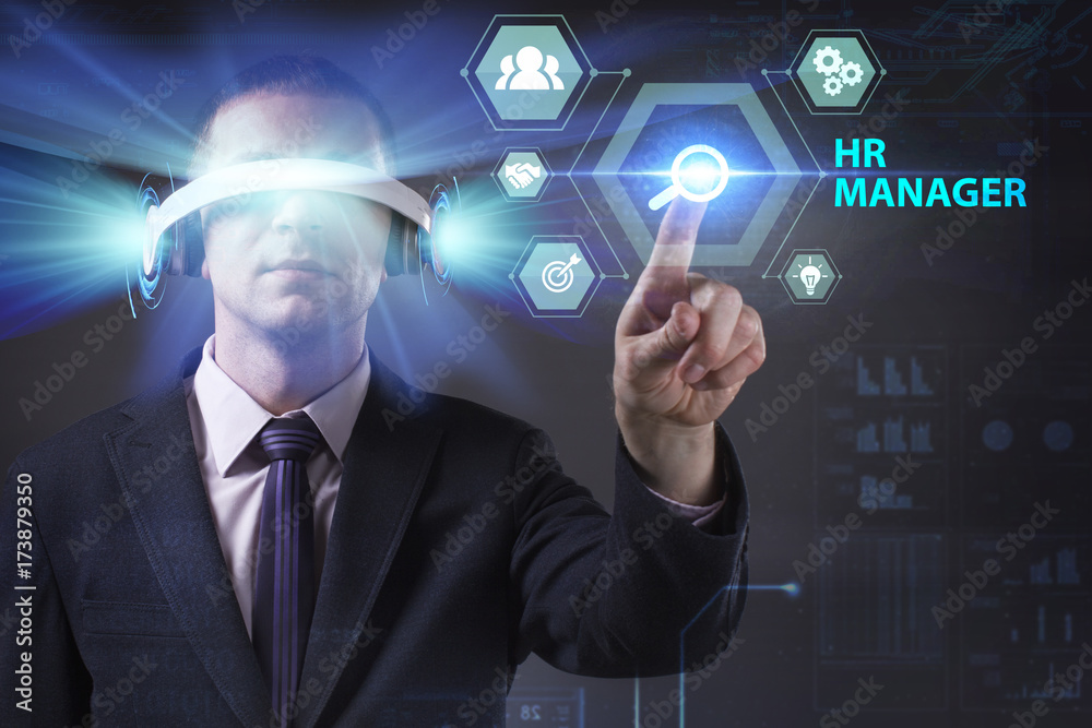 Business, Technology, Internet and network concept. Young businessman working in virtual reality glasses sees the inscription: HR manager Business, Technology, Internet and network concept. Young businessman working in virtual reality glasses sees the inscription: HR manager