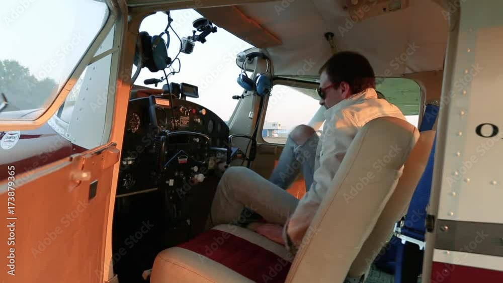 The pilot sits down in the cockpit. The pilot sits down in the cockpit.