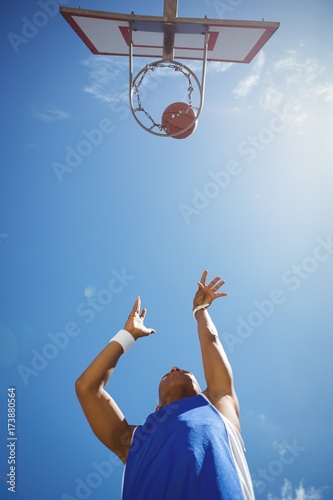 Directly below shot of male teenager playing basketball