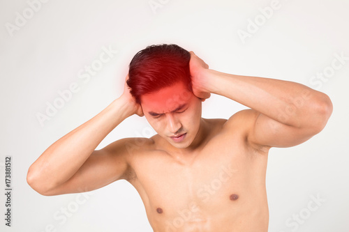 Man with head ache feeling pain. Studio shot on white background. Fitness and health concept