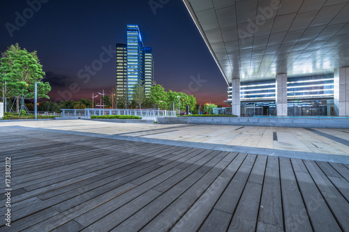 Empty wooden footpath front modern building.