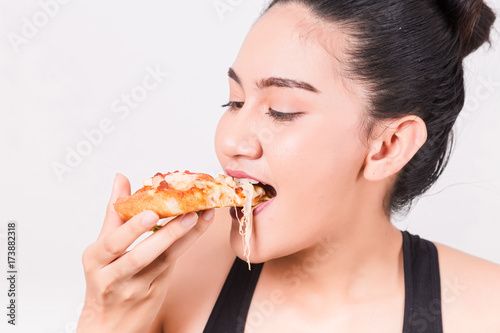 Happy girl eating tasty pizza. Isolated on a White Background.