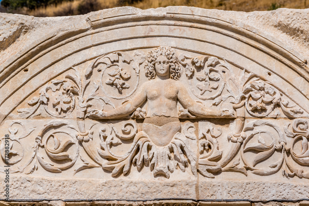 Marble reliefs in Ephesus historical ancient city, in Selcuk,Izmir,Turkey.Figure of Medusa with ornaments of Acanthus leaves,Detail of the Temple of Hadrian.