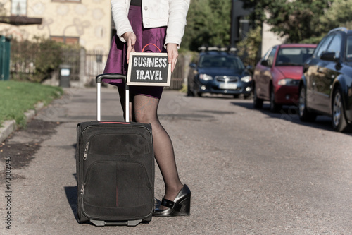 Business Travel concept. woman with travel bag on the street, getting ready for jorney.