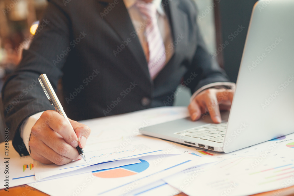 Young businessmen using Notebook and A pen Young businessmen using Notebook and A pen