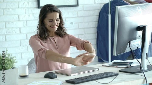 Businesswoman looks happy after having finished work and drinking coffee in the office, steadycam shot

