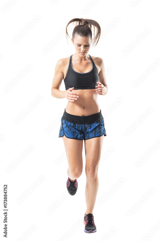 Front view of female jogger jogging and looking down. Full body length portrait isolated on white studio background. Front view of female jogger jogging and looking down. Full body length portrait isolated on white studio background.