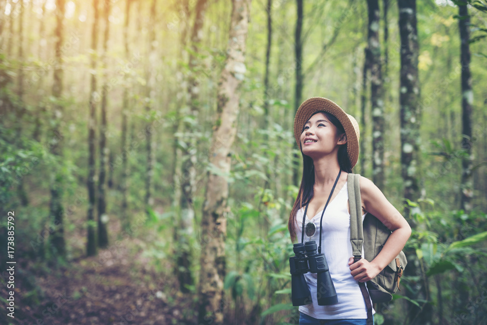 Woman with Binoculars and Telescope in Rain Forest.Travel concept. Woman with Binoculars and Telescope in Rain Forest.Travel concept.