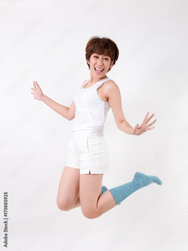 Woman jumping. Isolated on white background. Studio lighting. Woman jumping. Isolated on white background. Studio lighting.