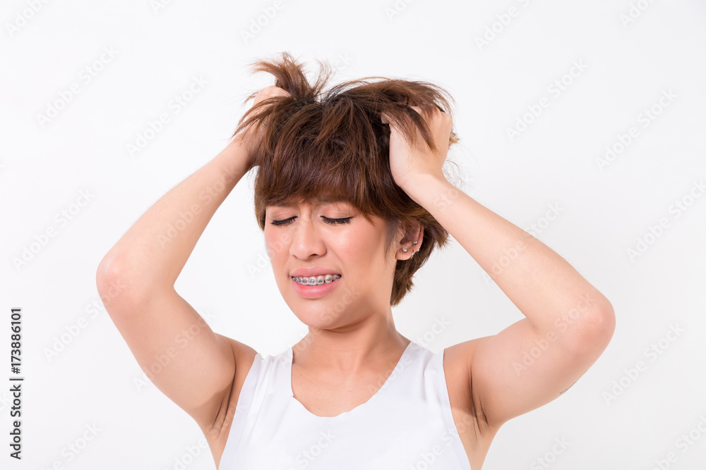 Health and pain. Stressed exhausted young woman having strong tension headache.  Isolated on white background. Studio lighting. Concept for healthy and medical