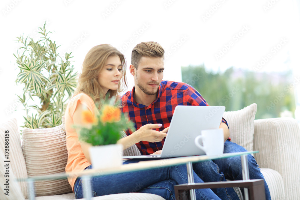 young woman showing important information to her boyfriend on the laptop screen young woman showing important information to her boyfriend on the laptop screen