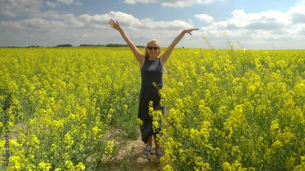 young blonde woman posing in beautiful rapeseed field young blonde woman posing in beautiful rapeseed field