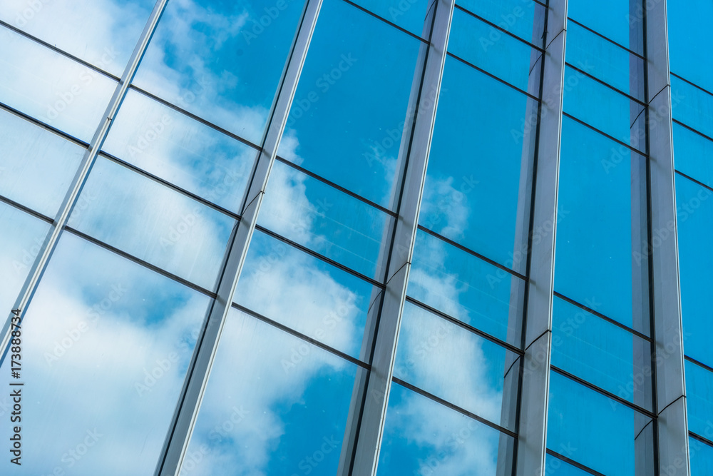 Fototapeta premium Clouds Reflected in Windows of Modern Office Building..