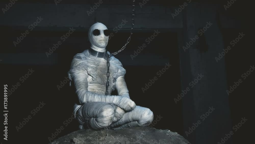 people being in bandages in a dark, abandoned building on the chain in custody people being in bandages in a dark, abandoned building on the chain in custody